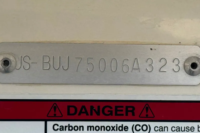 Slide: The Image of Hull identification number on 2023 Mako Pro Skiff 17 CC with carbon monoxide warning label. - 31