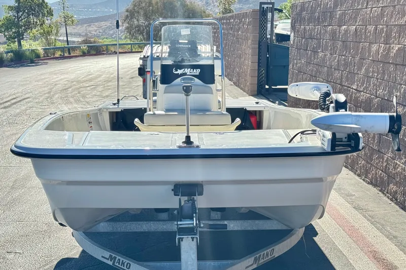 Slide: The Image of 2023 Mako Pro Skiff 17 CC boat on trailer, parked outdoors. - 2