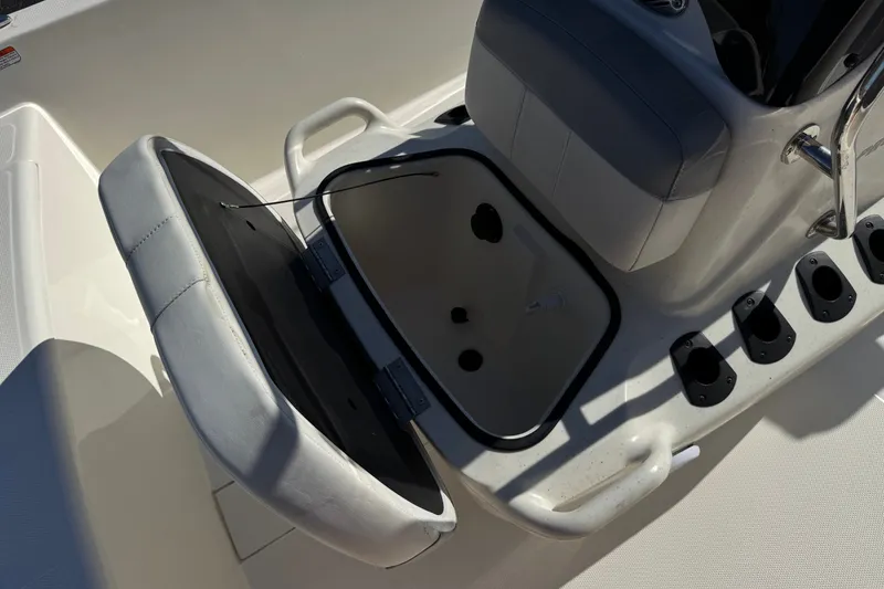 Slide: The Image of 2023 Mako Pro Skiff 17 CC boat seat with open storage compartment. - 17