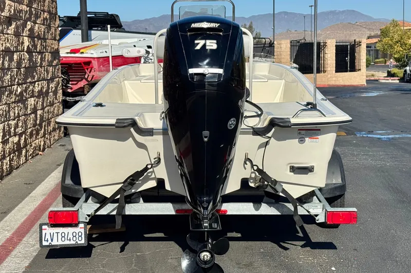 Slide: The Image of 2023 Mako Pro Skiff 17 CC boat with Mercury 75 engine on trailer. - 4