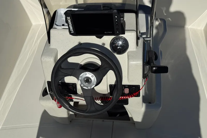 Slide: The Image of 2023 Mako Pro Skiff 17 CC console with steering wheel and Lowrance display. - 25