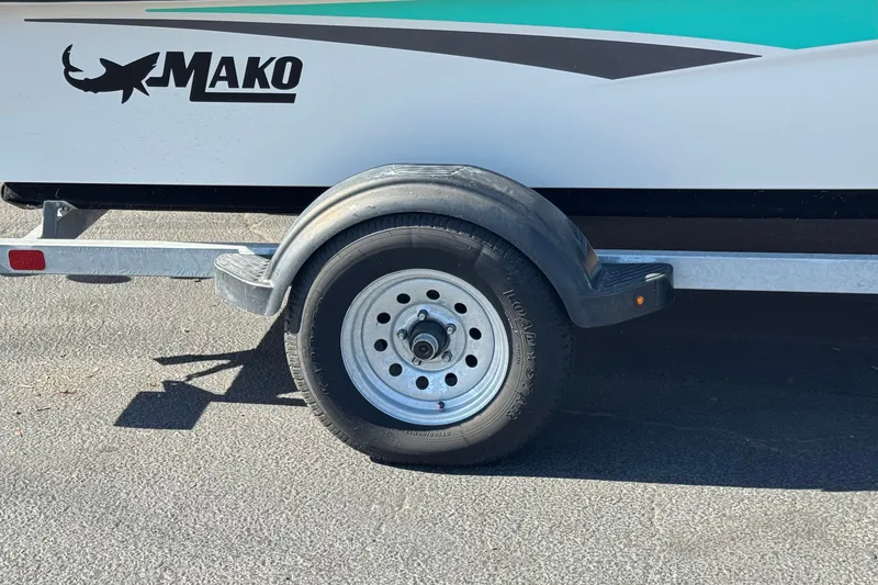Slide: The Image of Trailer wheel of 2023 Mako Pro Skiff 17 CC boat on pavement. - 28