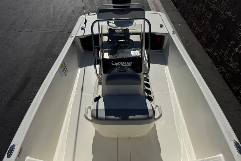 Slide: The Image of 2023 Mako Pro Skiff 17 CC boat interior with center console and seating. - 16