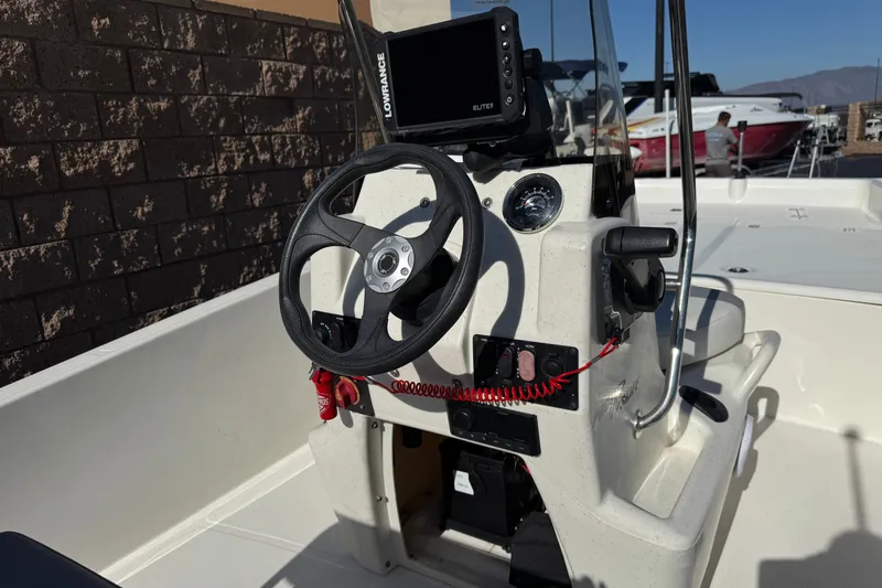 Slide: The Image of 2023 Mako Pro Skiff 17 CC boat console with steering wheel and navigation system. - 26