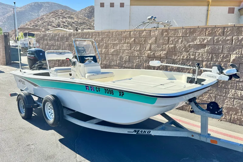 Slide: The Image of 2023 Mako Pro Skiff 17 CC boat on trailer, parked outdoors. - 1