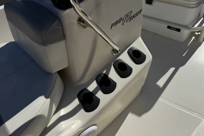 Slide: The Image of 2023 Mako Pro Skiff 17 CC boat interior with rod holders and seating. - 18