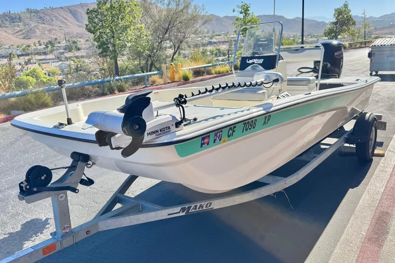 Slide: The Image of 2023 Mako Pro Skiff 17 CC boat on trailer, featuring Minn Kota trolling motor. - 3