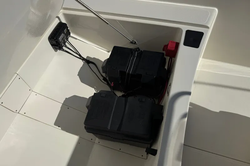 Slide: The Image of 2023 Mako Pro Skiff 17 CC battery compartment with wiring and components. - 14