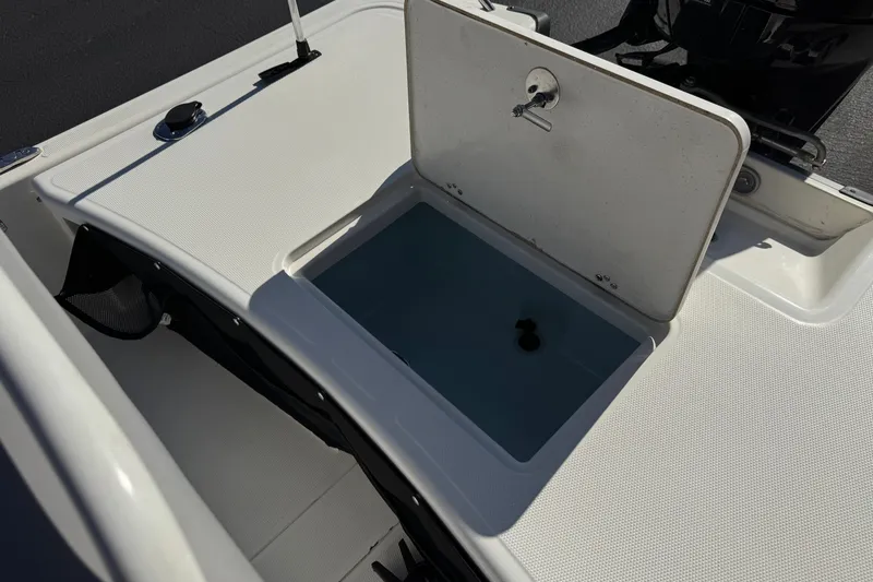 Slide: The Image of 2023 Mako Pro Skiff 17 CC boat with open storage compartment. - 22