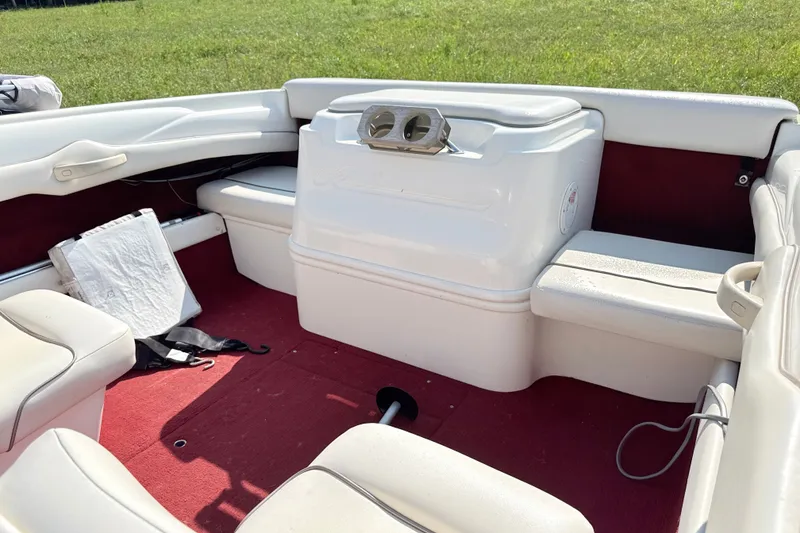 Slide: The Image of Interior of a 1995 Searay 195 boat with white seating and red carpet. - 5