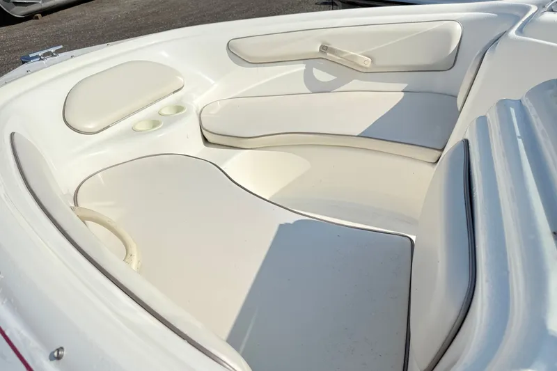 Slide: The Image of Interior seating of a 1995 Searay 195 boat, featuring white cushioned seats. - 7