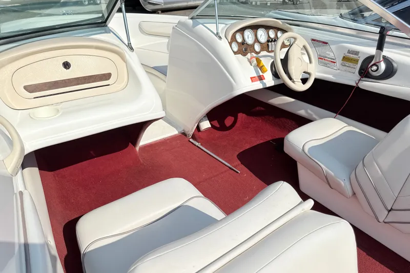 Slide: The Image of Interior of a 1995 Searay 195 boat with white seats and red carpet. - 4