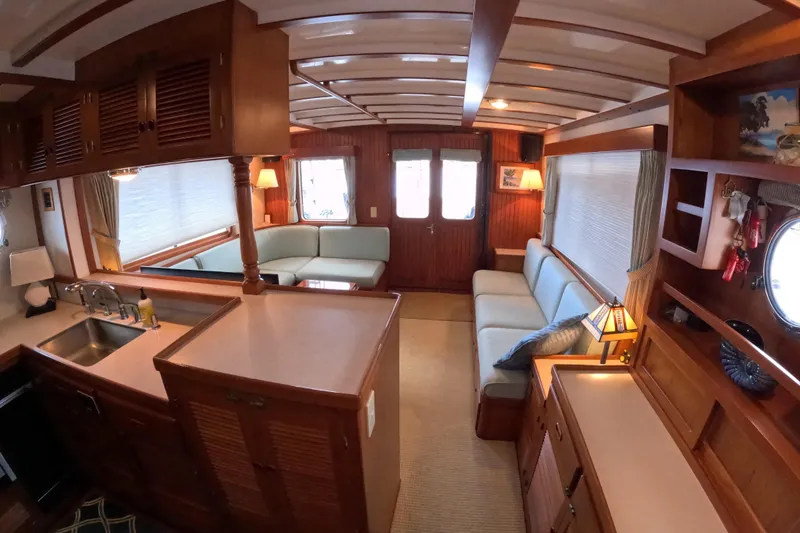 Slide: The Image of Interior of 1999 Kadey-Krogen 48 North Sea yacht with cozy seating and wooden cabinetry. - 12