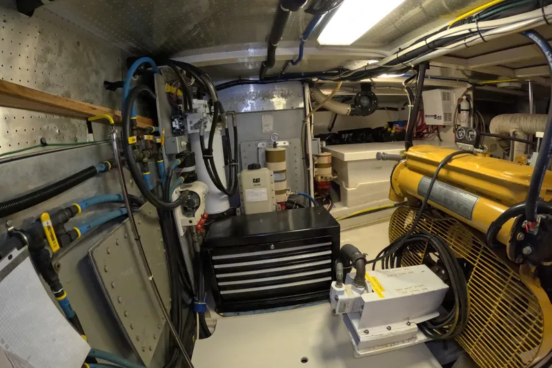Slide: The Image of Engine room of a 1999 Kadey-Krogen 48 North Sea yacht, featuring machinery and equipment. - 77