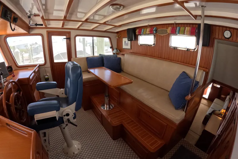 Slide: The Image of Interior of 1999 Kadey-Krogen 48 North Sea yacht with wooden accents and blue seating. - 22