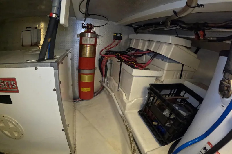 Slide: The Image of Engine room of 1999 Kadey-Krogen 48 North Sea yacht with fire extinguisher and equipment. - 88