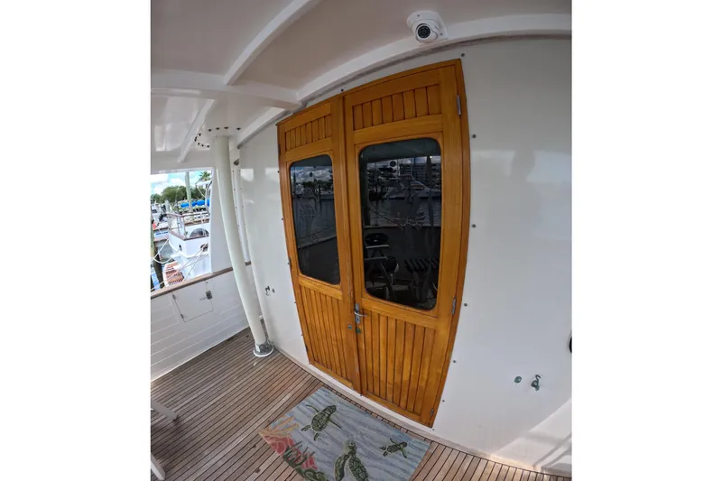 Slide: The Image of Wooden door on 1999 Kadey-Krogen 48 North Sea yacht, featuring teak deck and nautical decor. - 49