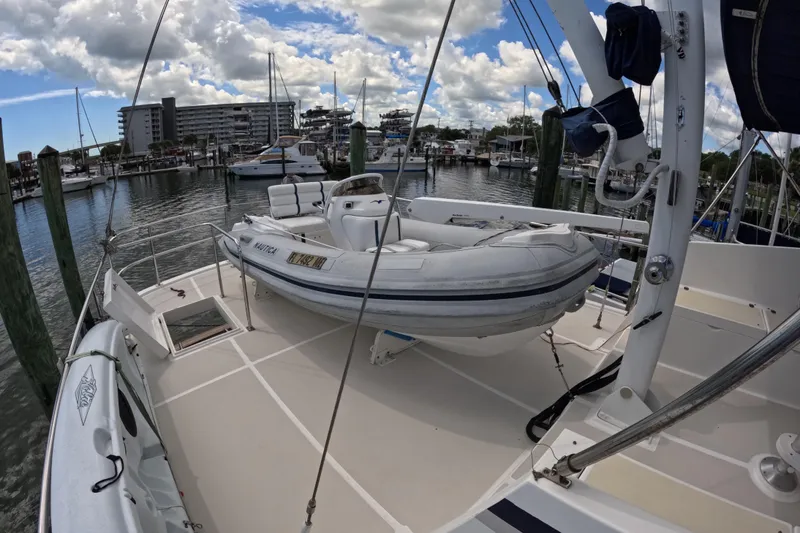 Slide: The Image of Kadey-Krogen 48 North Sea yacht deck with inflatable boat, docked at marina, 1999 model. - 74
