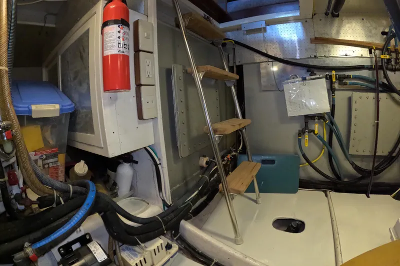 Slide: The Image of Engine room of 1999 Kadey-Krogen 48 North Sea yacht with equipment and fire extinguisher. - 91