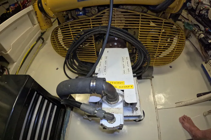 Slide: The Image of Engine room of 1999 Kadey-Krogen 48 North Sea yacht, featuring machinery and caution labels. - 89