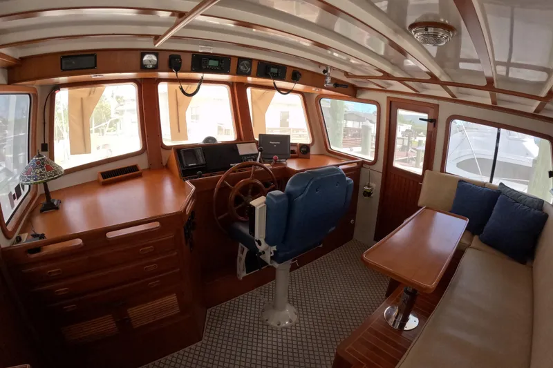 Slide: The Image of Interior of 1999 Kadey-Krogen 48 North Sea yacht with wooden helm and seating area. - 20
