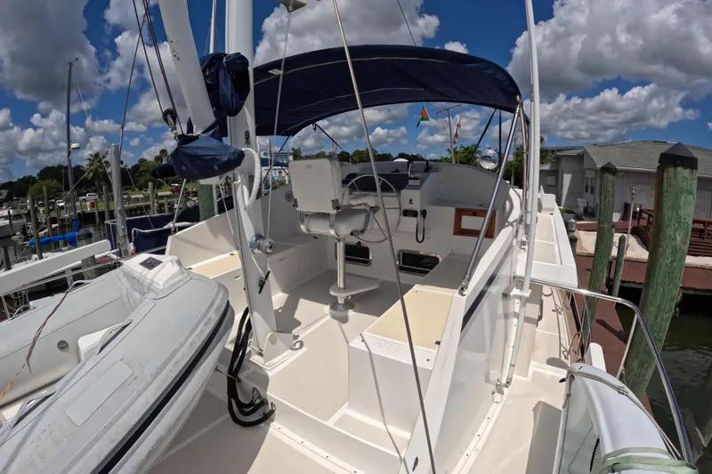 Slide: The Image of 1999 Kadey-Krogen 48 North Sea yacht cockpit with helm, docked under blue sky. - 64