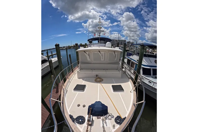 Slide: The Image of Kadey-Krogen 48 North Sea yacht docked, 1999 model, under a partly cloudy sky. - 54
