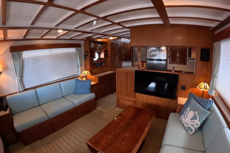 Slide: The Image of Luxurious 1999 Kadey-Krogen 48 North Sea yacht interior with elegant wood finishes and cozy seating. - 11