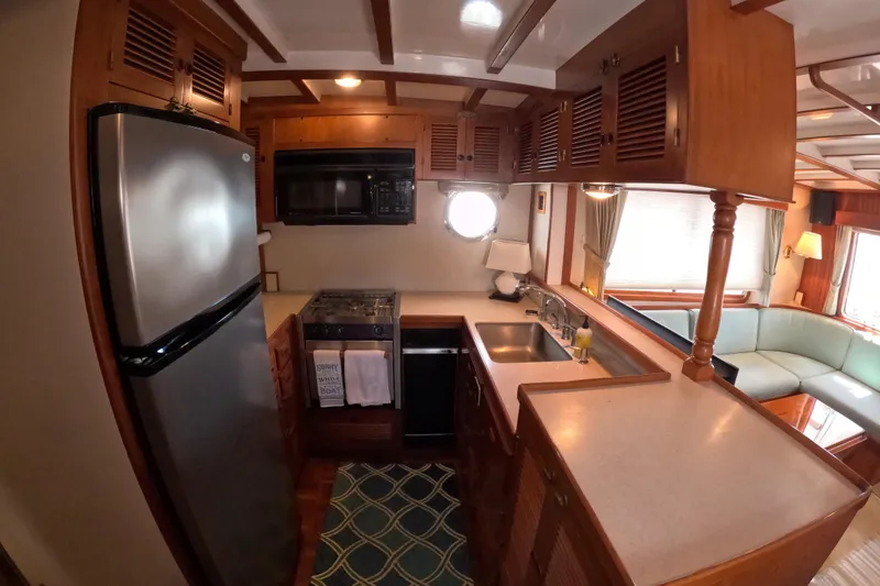 Slide: The Image of Cozy kitchen interior of 1999 Kadey-Krogen 48 North Sea yacht with modern appliances. - 13