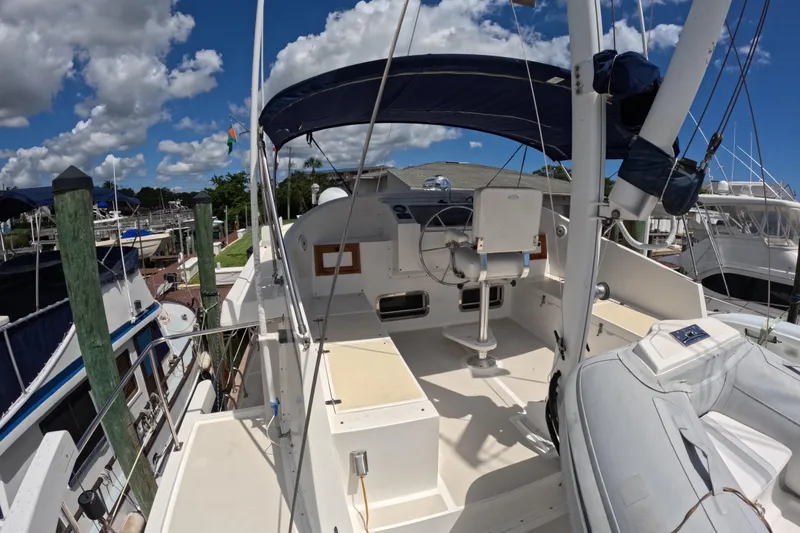 Slide: The Image of 1999 Kadey-Krogen 48 North Sea yacht with spacious deck and helm, docked under blue sky. - 63