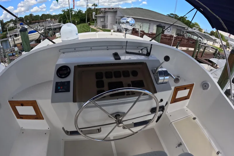 Slide: The Image of Helm of 1999 Kadey-Krogen 48 North Sea yacht with steering wheel and controls. - 69