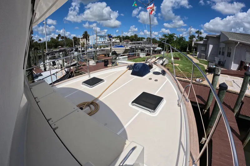 Slide: The Image of 1999 Kadey-Krogen 48 North Sea yacht docked at marina under blue sky. - 52