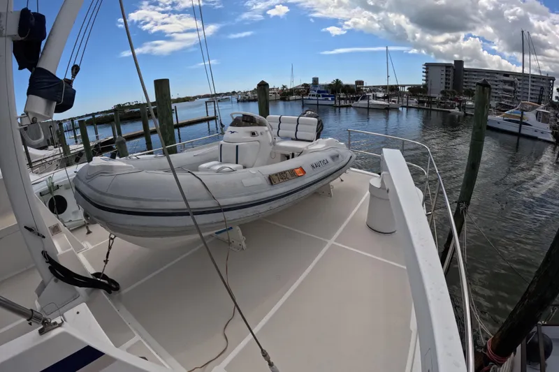 Slide: The Image of Kadey-Krogen 48 North Sea yacht with dinghy docked at marina, 1999 model. - 72