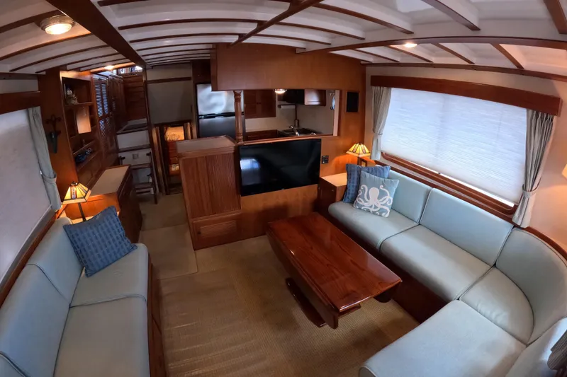 Slide: The Image of Luxurious 1999 Kadey-Krogen 48 North Sea yacht interior with elegant wood finishes and cozy seating. - 3