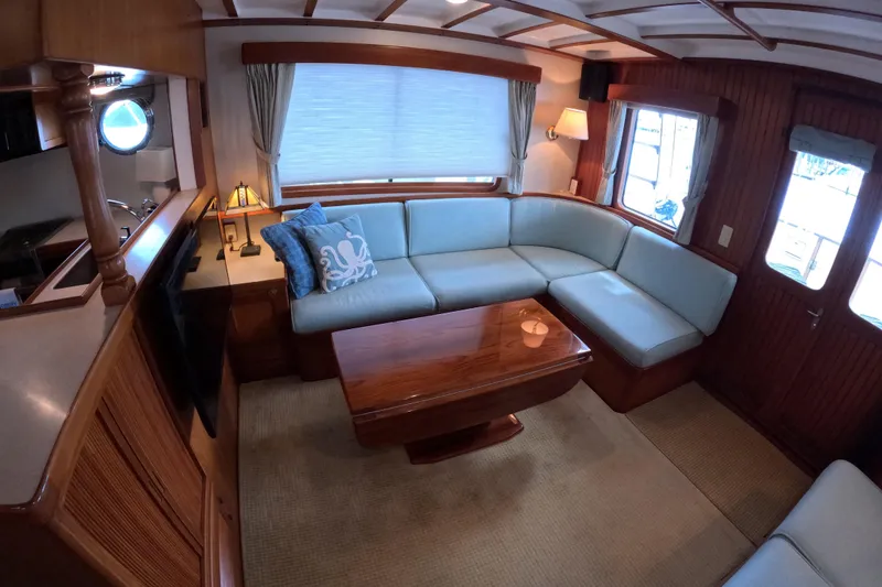 Slide: The Image of Luxurious 1999 Kadey-Krogen 48 North Sea yacht interior with elegant seating and wooden accents. - 4