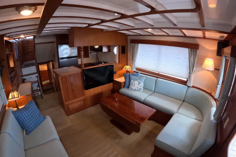 Slide: The Image of Luxurious 1999 Kadey-Krogen 48 North Sea yacht interior with elegant wood finishes and cozy seating. - 9