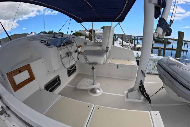 Slide: The Image of 1999 Kadey-Krogen 48 North Sea yacht helm with steering wheel and seating under canopy. - 66
