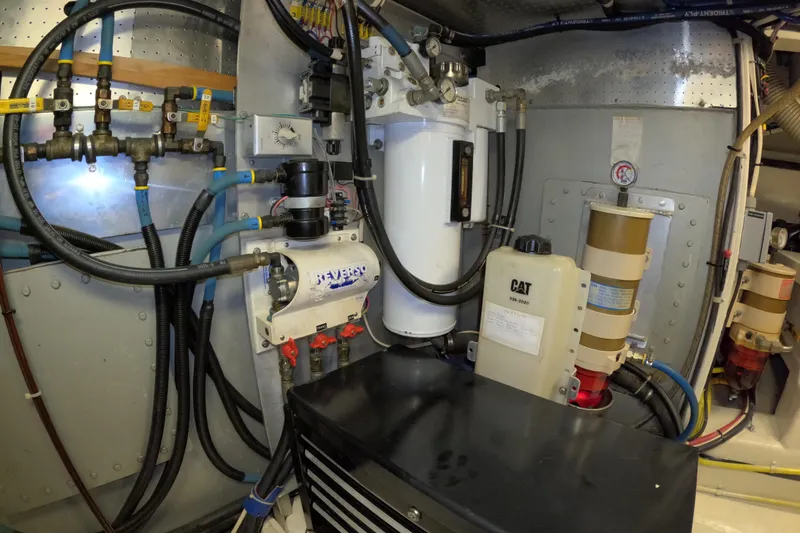 Slide: The Image of Engine room of 1999 Kadey-Krogen 48 North Sea yacht, featuring complex piping and machinery. - 87