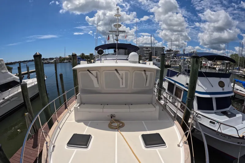 Slide: The Image of Kadey-Krogen 48 North Sea yacht docked at marina, 1999 model, under a bright blue sky. - 55