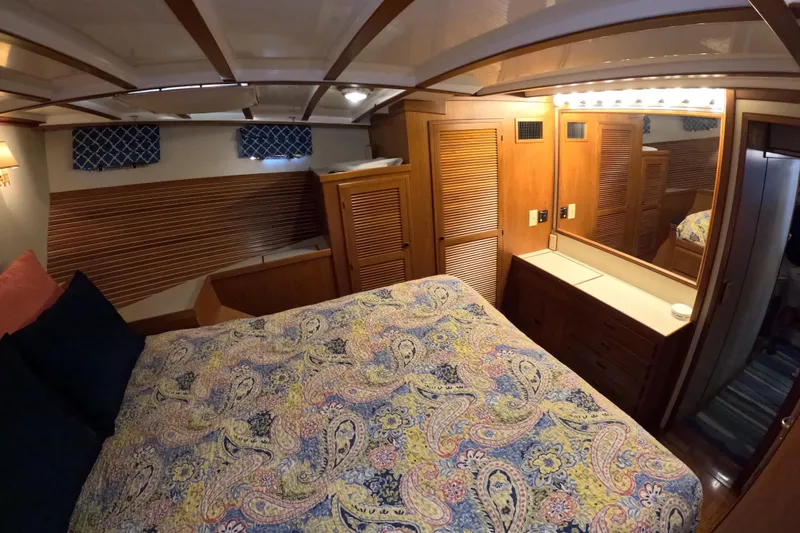 Slide: The Image of Cozy cabin interior of 1999 Kadey-Krogen 48 North Sea yacht with patterned bedding and wooden accents. - 30