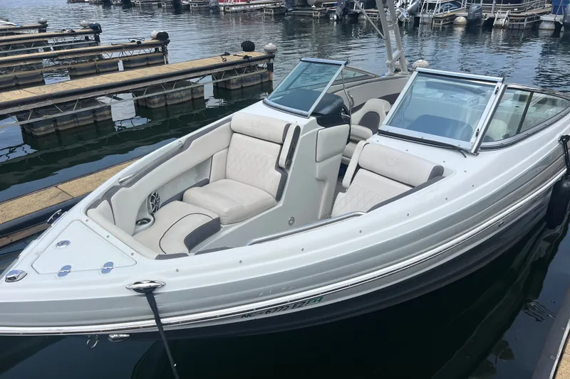 The Image of 2023 Crownline 240 SS SURF boat docked, featuring sleek design and comfortable seating. - 1