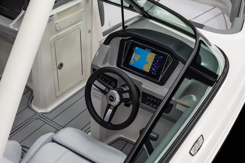 Slide: The Image of 2027 Chaparral 21 SSi boat dashboard with steering wheel and navigation display. - 8