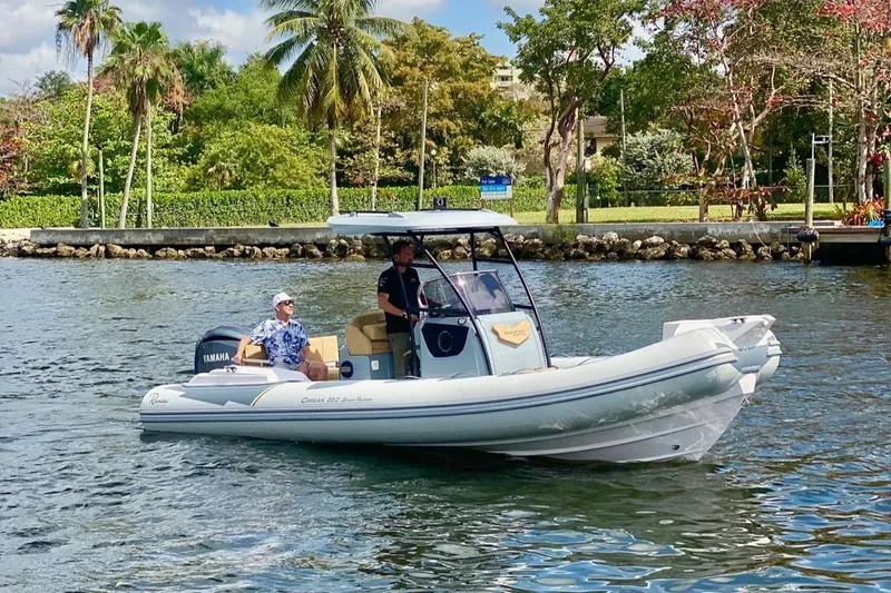 The Image of 2025 Ranieri Cayman 23.0 Sport Touring boat cruising on a scenic waterway. - 0