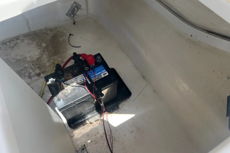 Slide: The Image of Battery compartment of 2020 Chaparral 23 SSi boat, showing installed marine battery. - 10