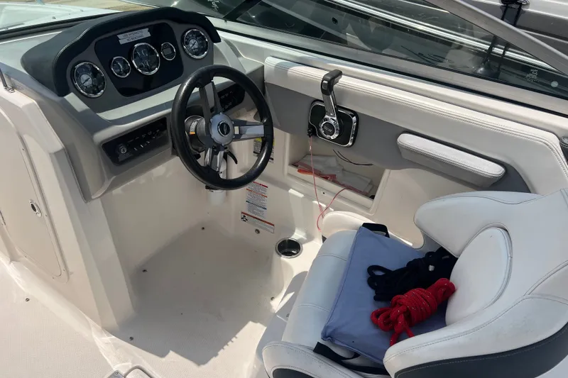 Slide: The Image of 2020 Chaparral 23 SSi boat cockpit with steering wheel and control panel. - 6