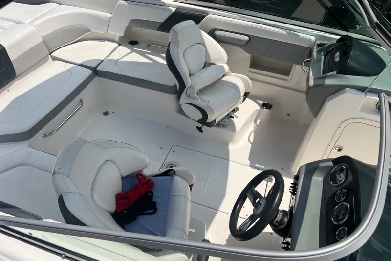 Slide: The Image of 2020 Chaparral 23 SSi boat interior with white seating and steering wheel. - 3