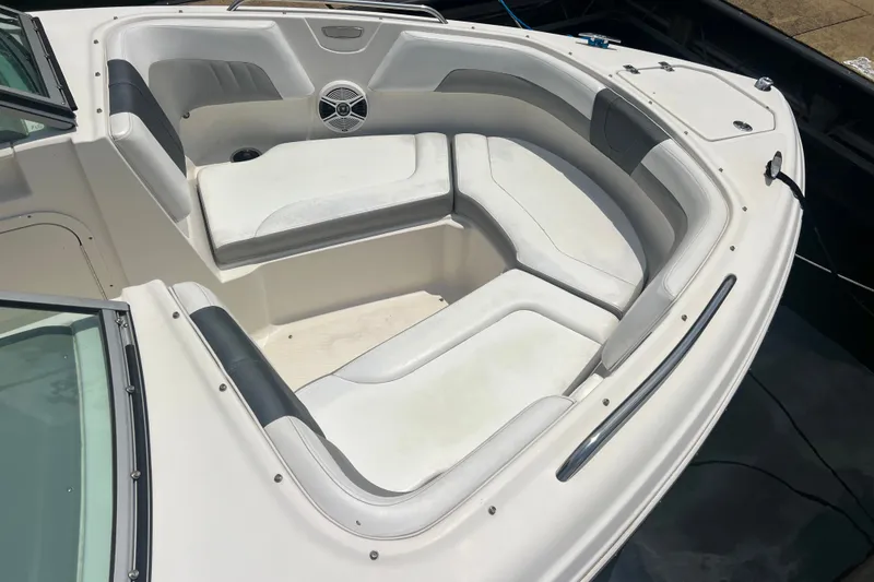 Slide: The Image of 2020 Chaparral 23 SSi boat interior with white cushioned seating and speaker. - 2
