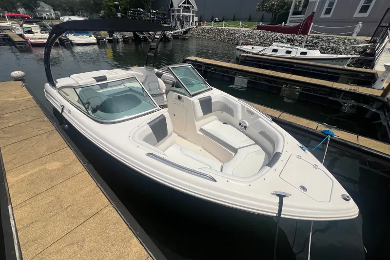 Slide: The Image of 2020 Chaparral 23 SSi boat docked at marina, featuring sleek design and spacious seating. - 1