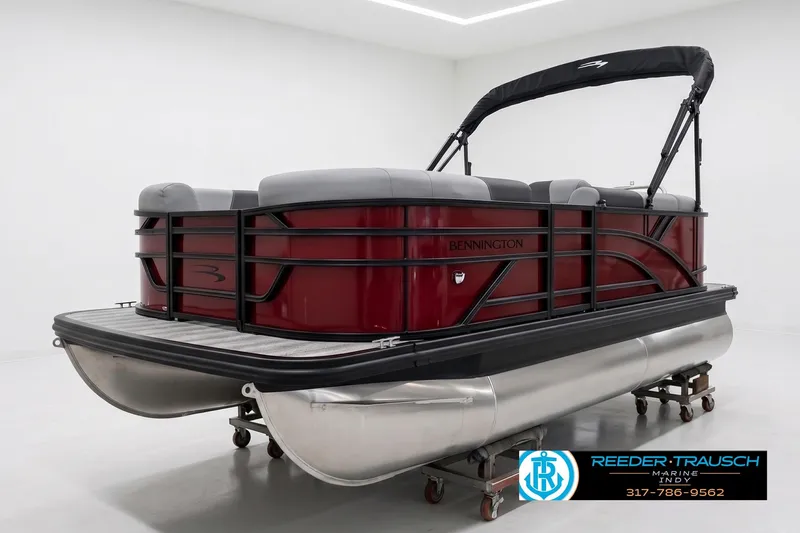Slide: The Image of 2027 Bennington 168 SLJ pontoon boat with red exterior and black canopy in showroom. - 2