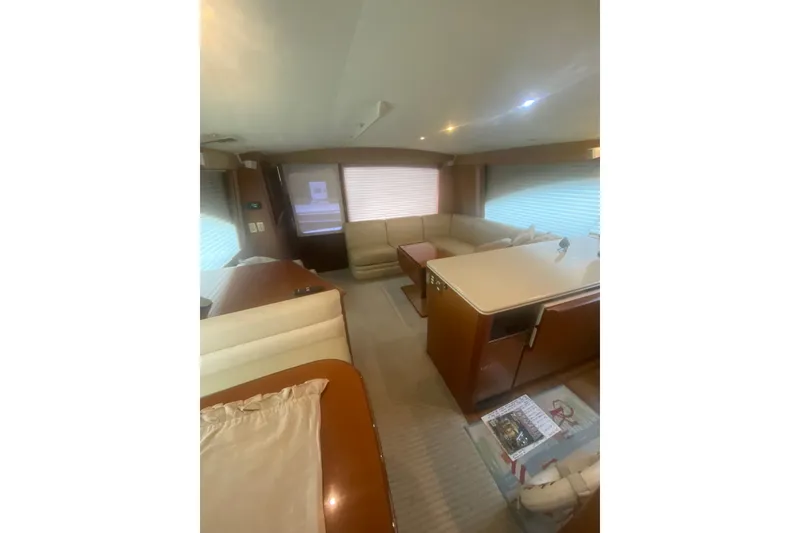 Slide: The Image of Interior of a 2005 Ocean Yacht 50' Super Sport, featuring a cozy seating area and modern design. - 21